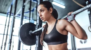 Young Fit Female Focused Intense Barbell Squat Pakistan Gym Everfit Fitness